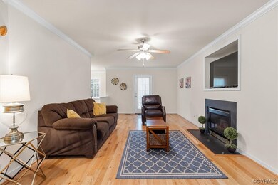 Living Room with hardwood floors, crown moulding,