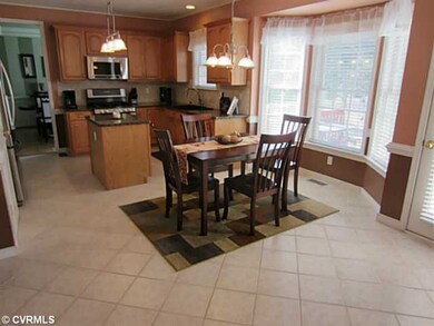 Kitchen - Sun Drenched Eat-in Area of Kitchen offers a Bay Window and Nearby Door leads to the Rear Deck. Kitchen has Gas Cooking and Island for Easy Meal Preparation and a Pantry to store all your Goodies and Kitchen Appliances.