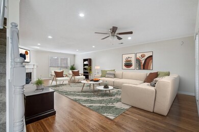 Living room with ceiling fan, wood finished floors