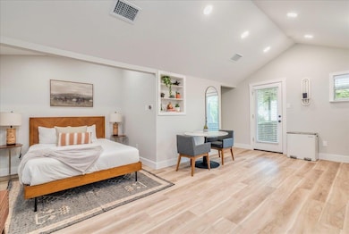 Bedroom featuring access to exterior, light wood-