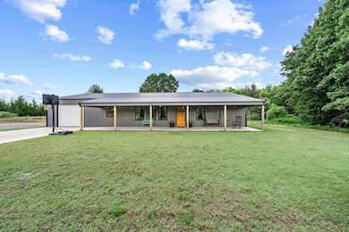 View of front of home featuring a garage, a front lawn, and concrete driveway