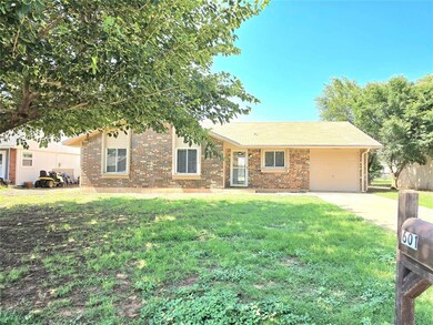 Single story home featuring a garage and a front y