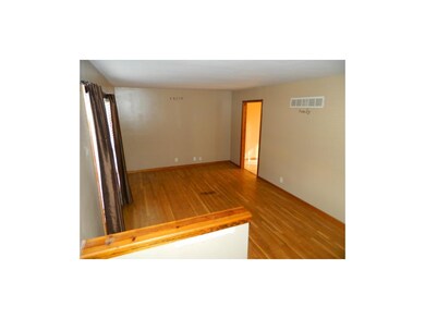 Large family room with nice hardwoods and big wind