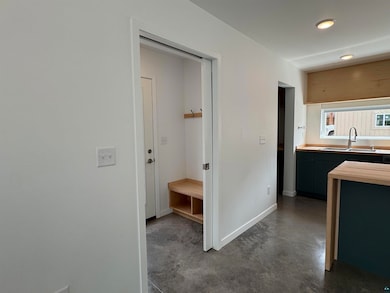 Hallway featuring concrete floors and recessed lighting