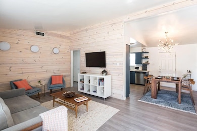 Living room with a chandelier, wood finished floo