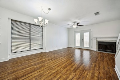 Unfurnished living room featuring a fireplace, ce