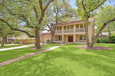 View of front of house with stone siding, a balco