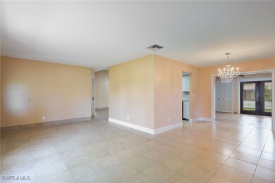 Front entry living room with a notable chandelier