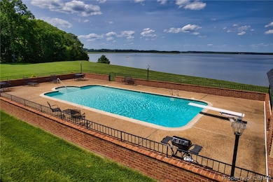
Pool is surrounded by brick-paver patio w/ fe