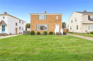 View of front of property with brick siding and a chimney