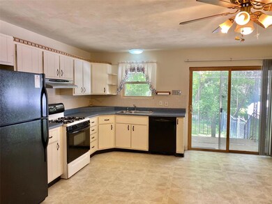 Large spacious eat-in kitchen with view of wooded back yard.