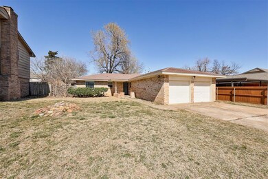 Single story home with brick siding, concrete driv