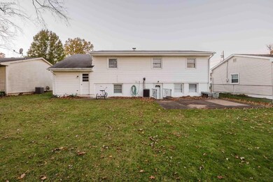 Back view w/lower level door and patio.