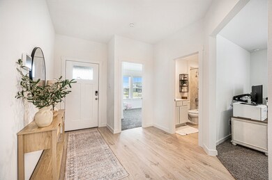 Welcoming front door entryway with access to the b
