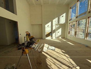 Misc room featuring a towering ceiling