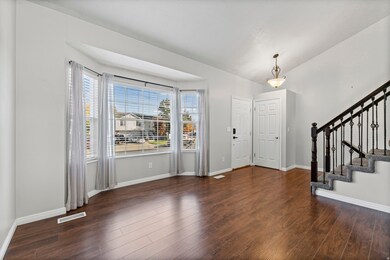 Entrance foyer with stairway and dark wood-style floors