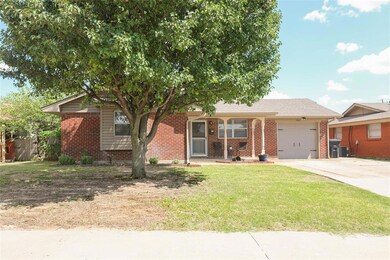 Single story home featuring a garage and a front y