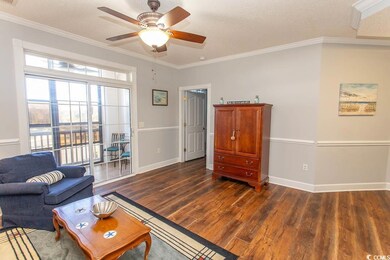 Living room with a textured ceiling, baseboards, d