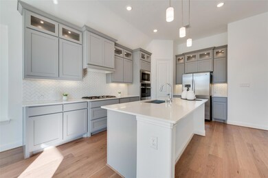 Kitchen with light wood-type flooring, stainless s
