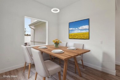 Dining space with baseboards and wood finished floors