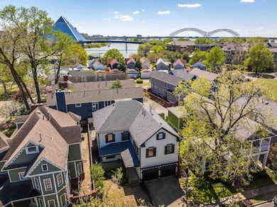 Aerial view of residential area featuring a large body of water and a notable bridge