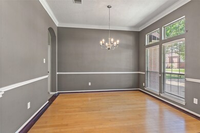 Formal dining has hardwood floors, chair rail and