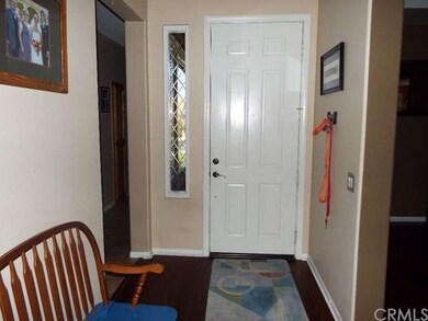Wood floor entry. Diamond etched windows.