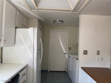 Laundry room with separate washer and dryer and ti
