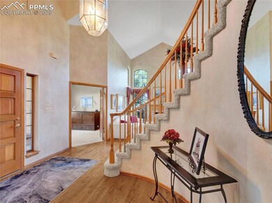 Entryway featuring wood finished floors, a high ce