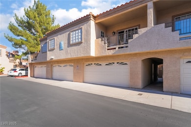 View of front facade with an attached garage, a ti