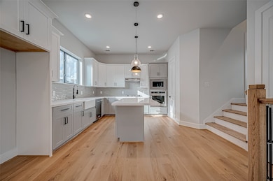 This modern kitchen features sleek white and gray