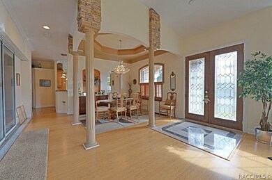 View of front entry and dining area with tray ceil