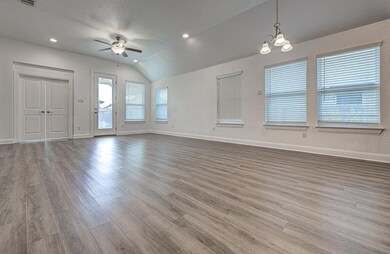 Unfurnished living room with a ceiling fan, wood 