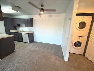 Kitchen with estacked washer and dryer, white dish