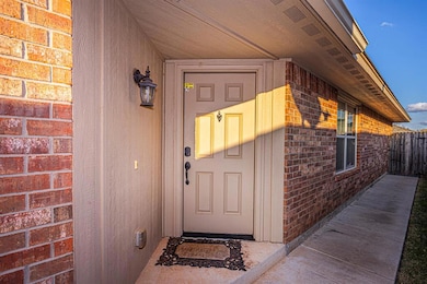 Entrance to property featuring brick siding