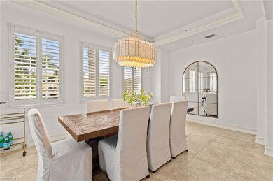 Dining room featuring a tray ceiling, crown moldin