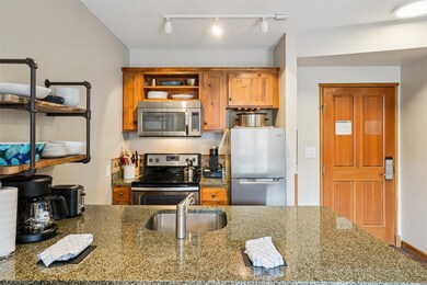 Kitchen featuring stainless steel appliances, a si
