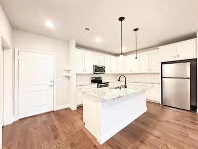 Kitchen featuring a sink, stainless steel applianc