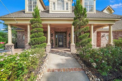 A paved walkway with brick accents leads from the street & sidewalk to the beautiful covered front porch supported by decorative columns. Creating a courtyard-like feel, features include a 30' x 19' covered porch with an extended brick patio & brick flooring. The entrance of the home is illuminated by large, natural gas lit coach lanterns and nearby is access to the backyard via a wrought iron fence & gate.