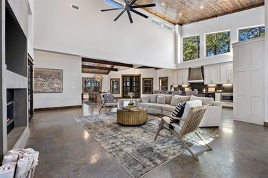 Living room featuring wood ceiling, ceiling fan wi