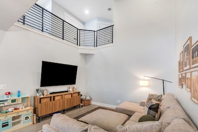 Living area with a high ceiling and wood finished floors