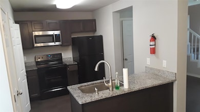 Kitchen with kitchen peninsula, dark brown cabinet