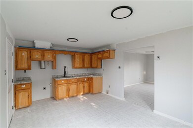 Kitchen with sink and light tile floors