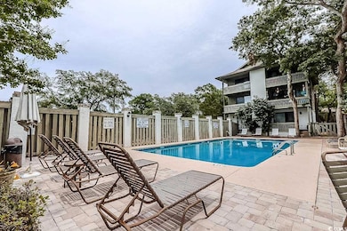 Community pool with a patio area