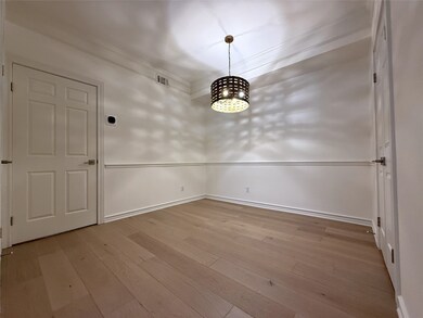 The dining room with classy light fixture and chai