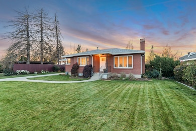 View of front of property with brick siding and a chimney