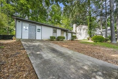 Ranch-style house featuring concrete driveway