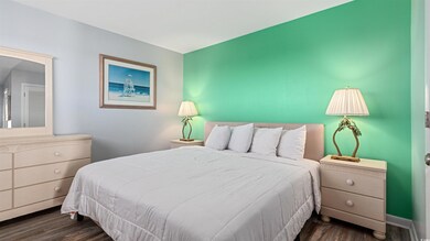Bedroom featuring dark wood-style flooring