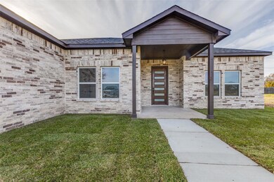 Doorway to property featuring brick siding and a y