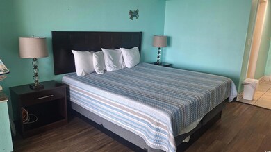 Bedroom featuring wood finished floors and baseboards